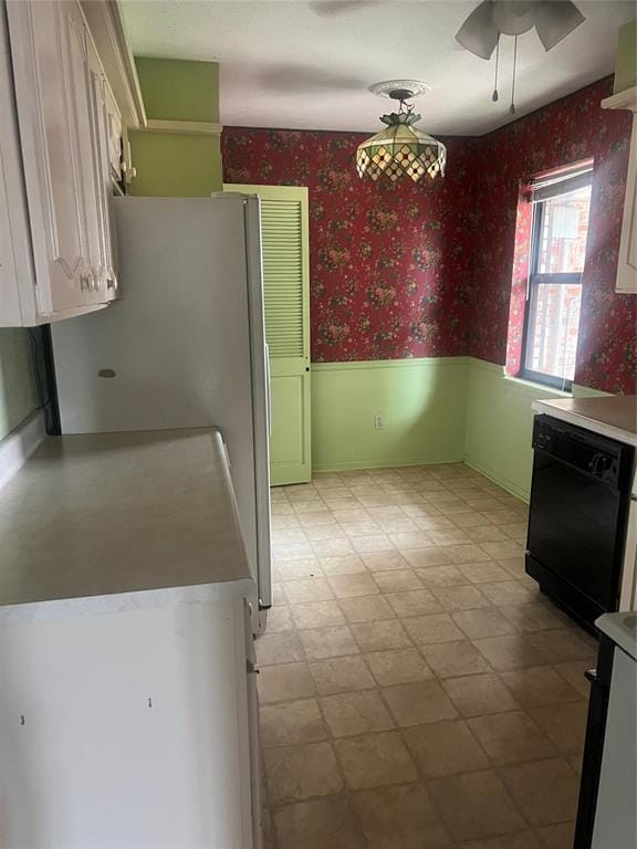 kitchen with white cabinets, black dishwasher, and ceiling fan