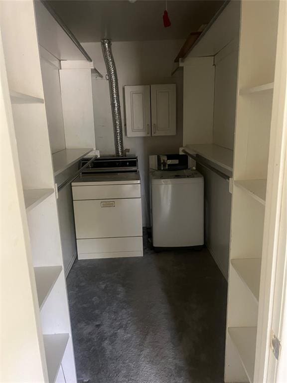 laundry area with washing machine and clothes dryer and cabinets