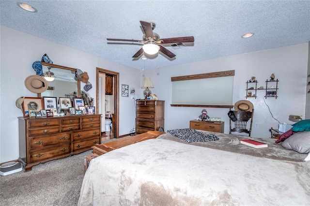 bedroom featuring carpet flooring, ceiling fan, and a textured ceiling