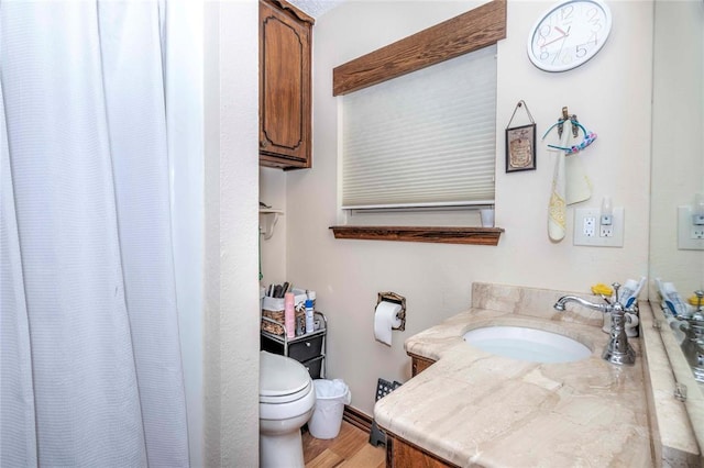 bathroom featuring hardwood / wood-style floors, vanity, and toilet