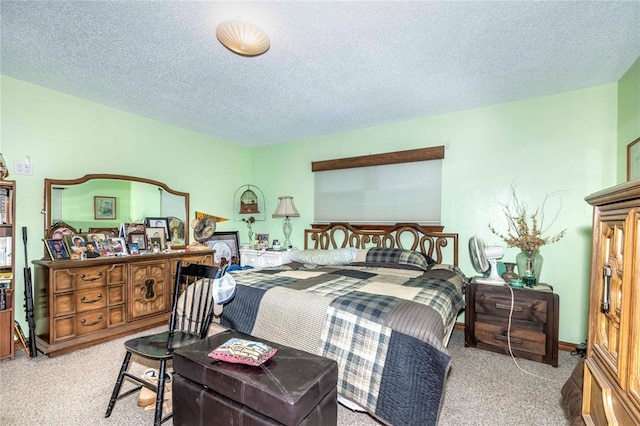 bedroom with light colored carpet and a textured ceiling