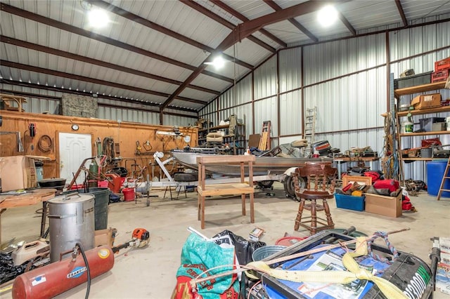 garage featuring a workshop area and wooden walls