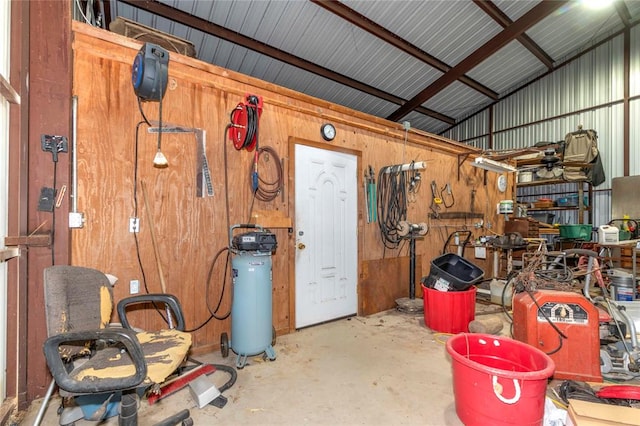 garage featuring wood walls