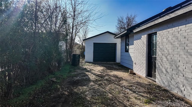 view of side of property with an outdoor structure and a garage