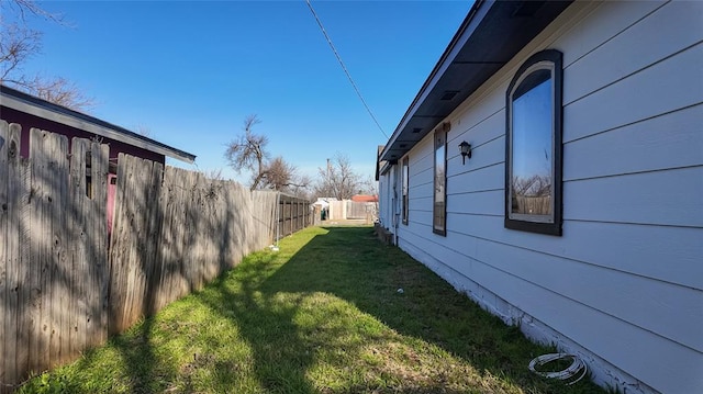 view of side of property with a lawn