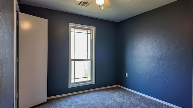 carpeted spare room with a healthy amount of sunlight