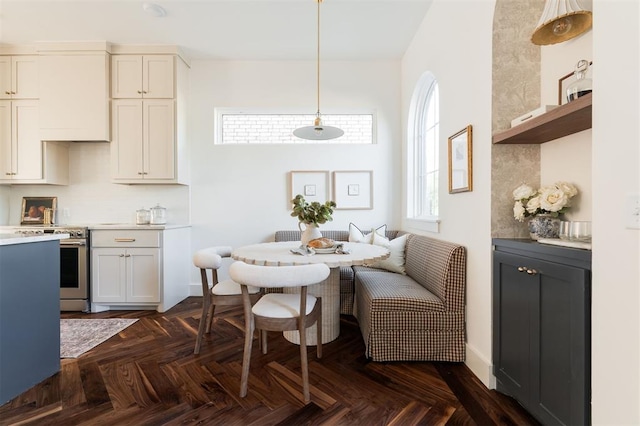 dining area featuring dark parquet flooring and breakfast area