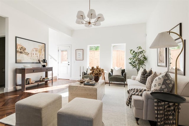 living room with light wood-type flooring and an inviting chandelier