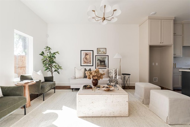 living room featuring light hardwood / wood-style flooring and an inviting chandelier