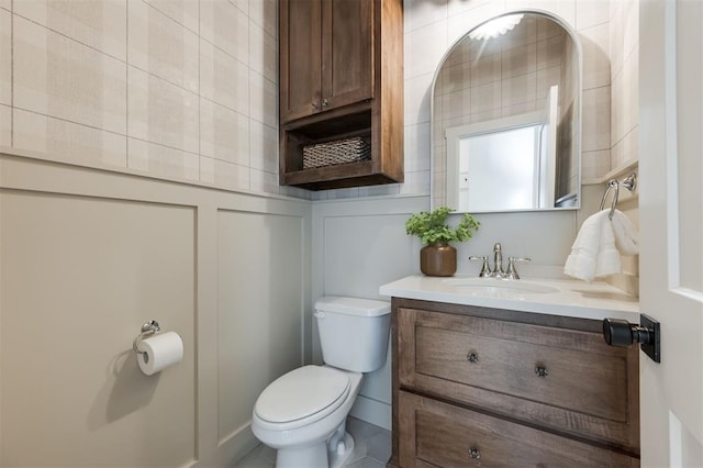 bathroom with tile patterned floors, vanity, and toilet