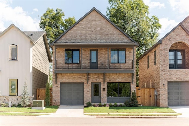 view of front facade featuring a garage, a balcony, and a front yard