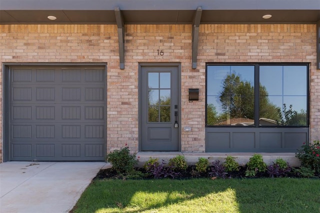 doorway to property with a garage