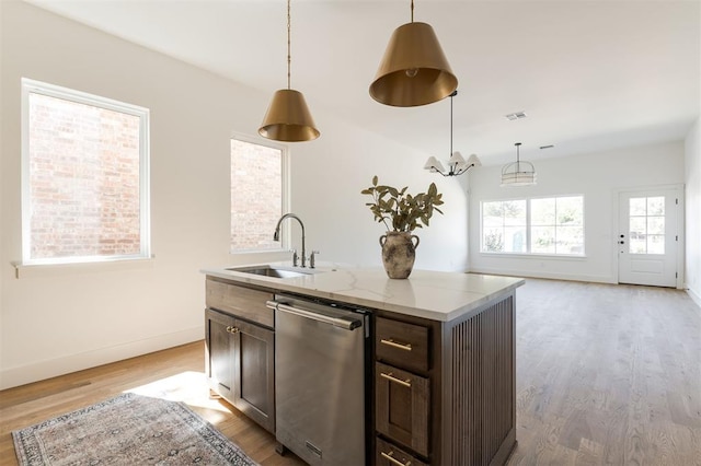 kitchen with dishwasher, pendant lighting, and light wood-type flooring