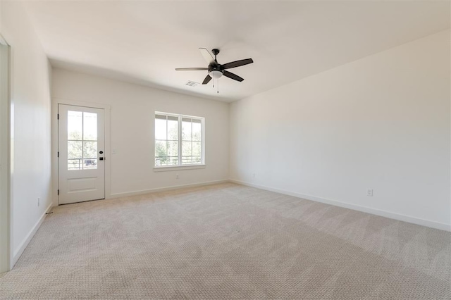 unfurnished room featuring light carpet and ceiling fan