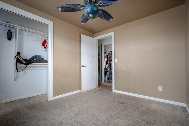 unfurnished bedroom featuring ceiling fan, light carpet, and a closet