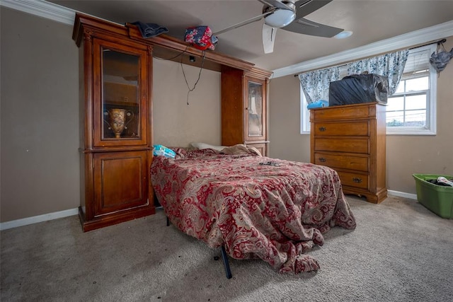 carpeted bedroom featuring ceiling fan and crown molding