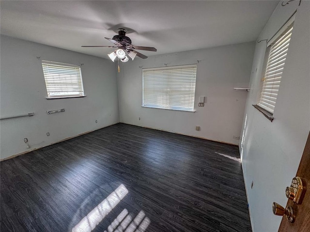 empty room with ceiling fan and dark hardwood / wood-style floors