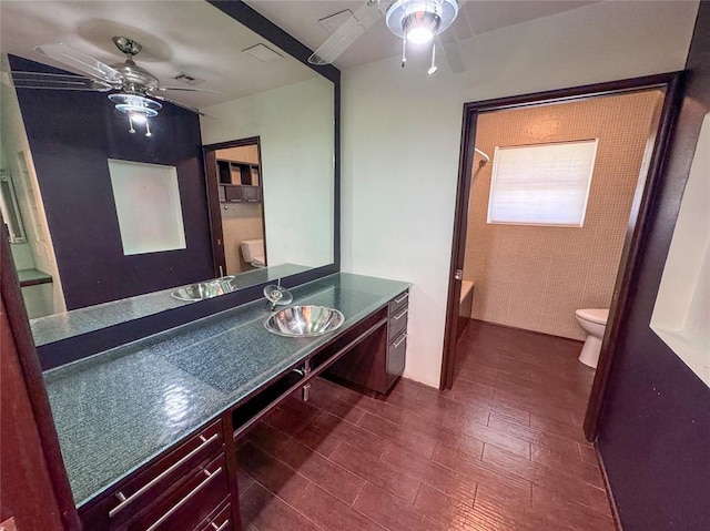 1345 State Highway 1, Hartshorne, OK 74547 - bathroom featuring ceiling fan, toilet, vanity, and shower / bath combination