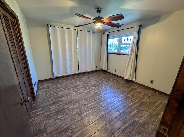 unfurnished bedroom featuring ceiling fan and dark hardwood / wood-style flooring