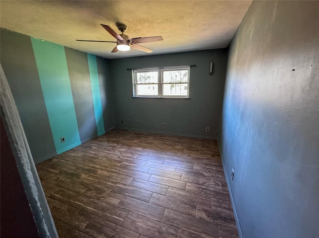 spare room featuring ceiling fan and dark hardwood / wood-style flooring