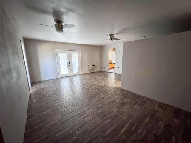 unfurnished room featuring dark hardwood / wood-style floors, ceiling fan, an AC wall unit, and french doors