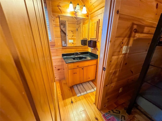 1345 State Highway 1, Hartshorne, OK 74547 - bathroom featuring wood-type flooring, vanity, and wood walls