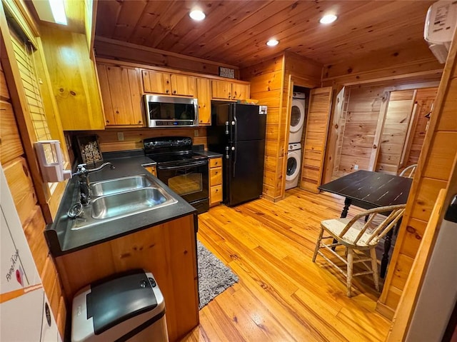 1345 State Highway 1, Hartshorne, OK 74547 - kitchen with black appliances, stacked washer and clothes dryer, dark countertops, a sink, and recessed lighting