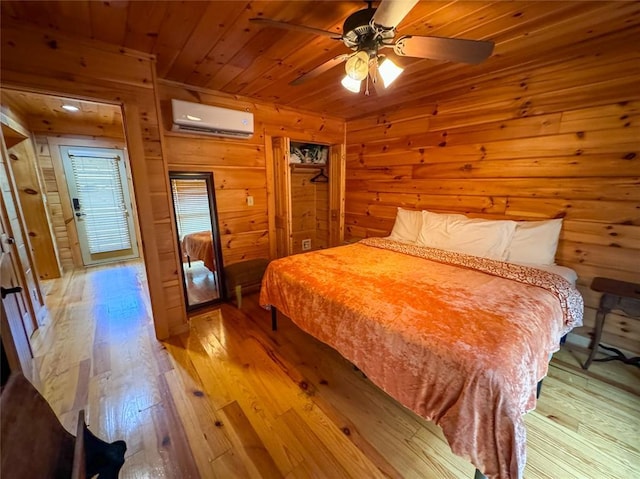 1345 State Highway 1, Hartshorne, OK 74547 - bedroom featuring a wall mounted AC, light wood finished floors, wood walls, and wooden ceiling