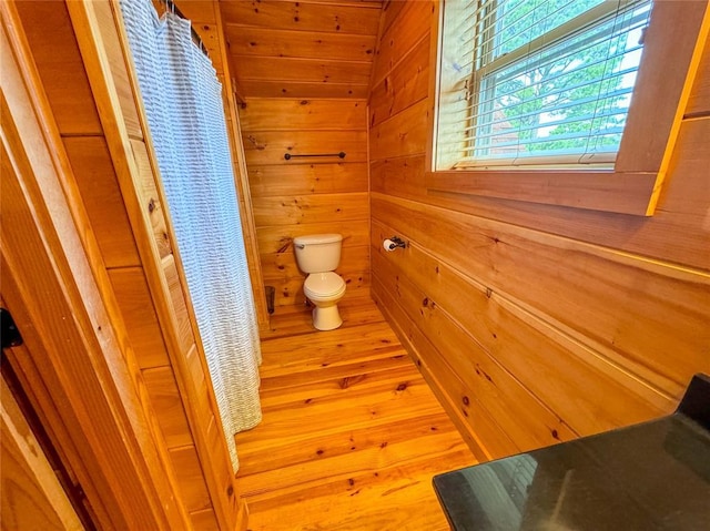 1345 State Highway 1, Hartshorne, OK 74547 - full bath featuring toilet, wooden walls, wood finished floors, and a shower with curtain