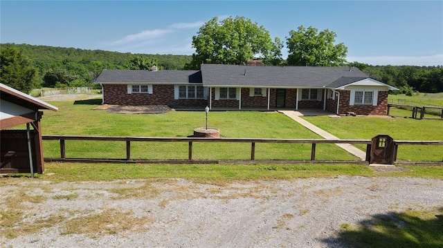 1345 State Highway 1, Hartshorne, OK 74547 - ranch-style home with a wooded view, brick siding, a chimney, and a porch