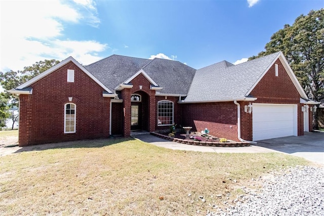 view of front of house featuring a front yard and a garage