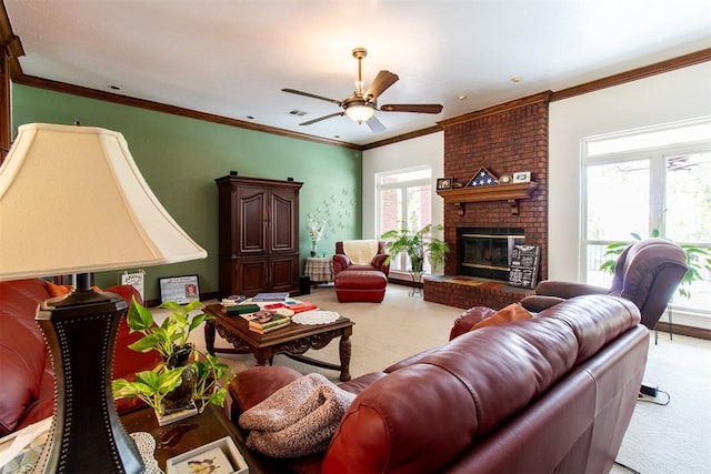 living room featuring a brick fireplace, ceiling fan, and crown molding