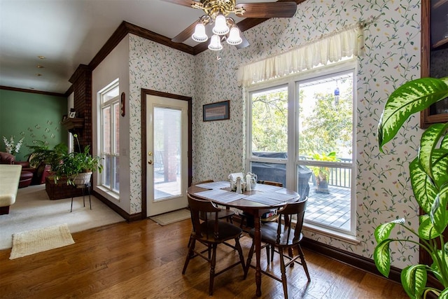 dining space with ceiling fan, dark hardwood / wood-style flooring, and ornamental molding