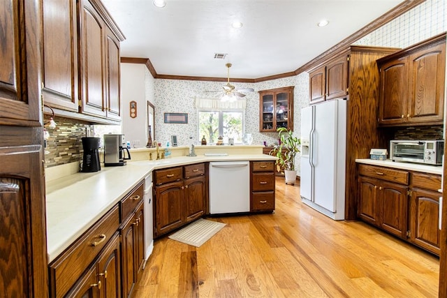 kitchen with white appliances, light hardwood / wood-style floors, hanging light fixtures, and ceiling fan