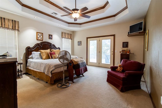 bedroom with access to outside, ceiling fan, and a tray ceiling