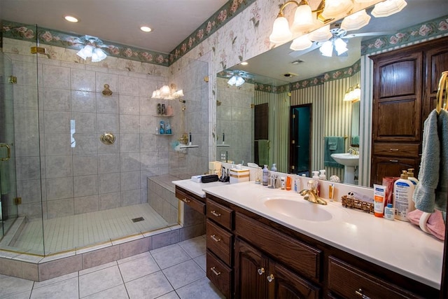 bathroom featuring tile patterned floors, sink, and a shower with door