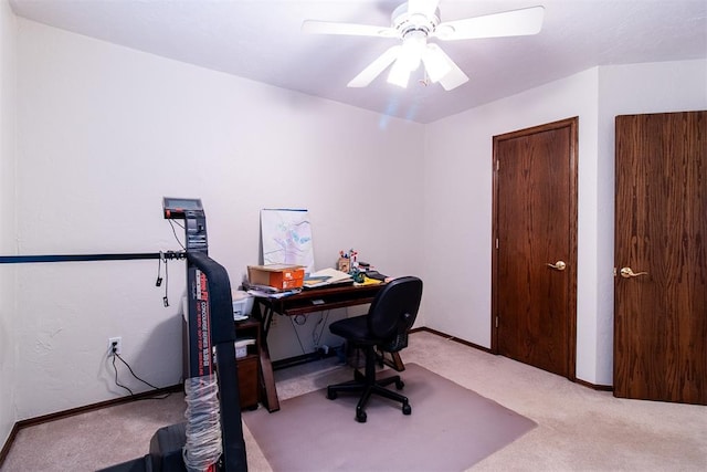 carpeted home office featuring ceiling fan