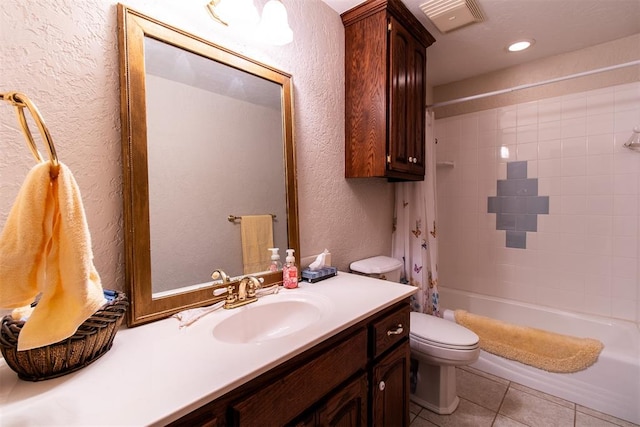 full bathroom featuring tile patterned floors, vanity, toilet, and shower / tub combo