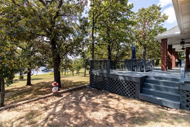 view of yard with ceiling fan and a wooden deck