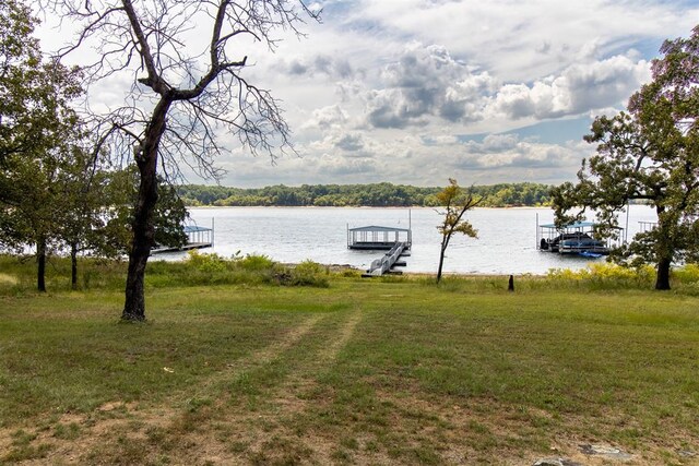 exterior space with a water view and a dock