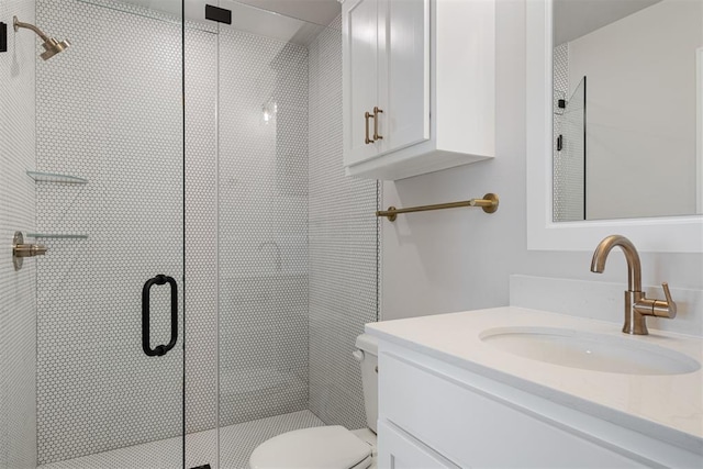 bathroom featuring vanity, toilet, and walk in shower