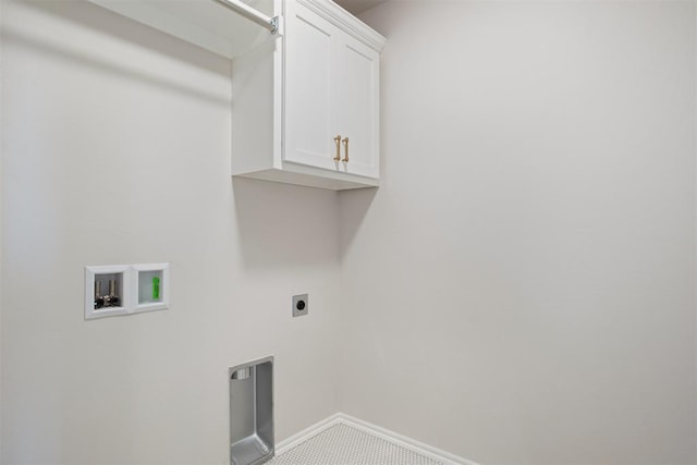 clothes washing area with electric dryer hookup, hookup for a washing machine, and cabinets