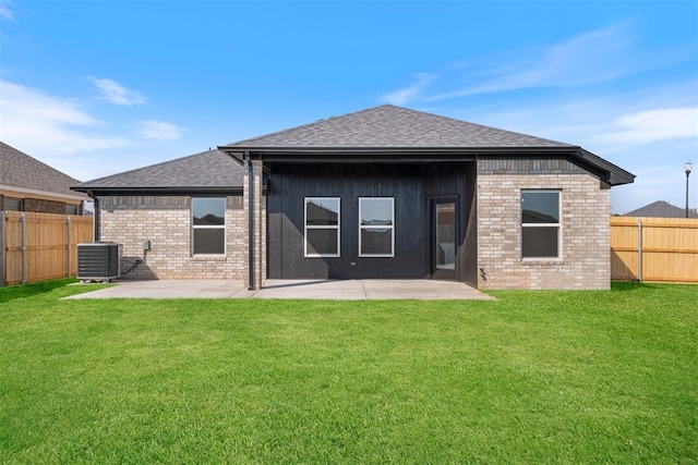 rear view of property with a lawn, central air condition unit, and a patio