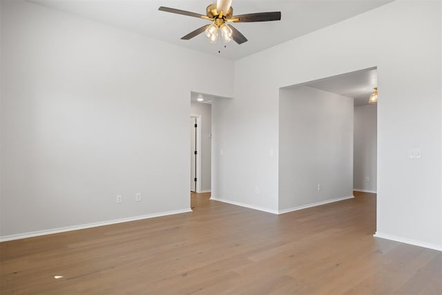 empty room featuring ceiling fan and light hardwood / wood-style flooring