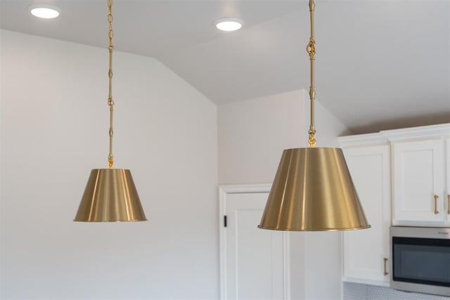 interior details with white cabinets and decorative light fixtures