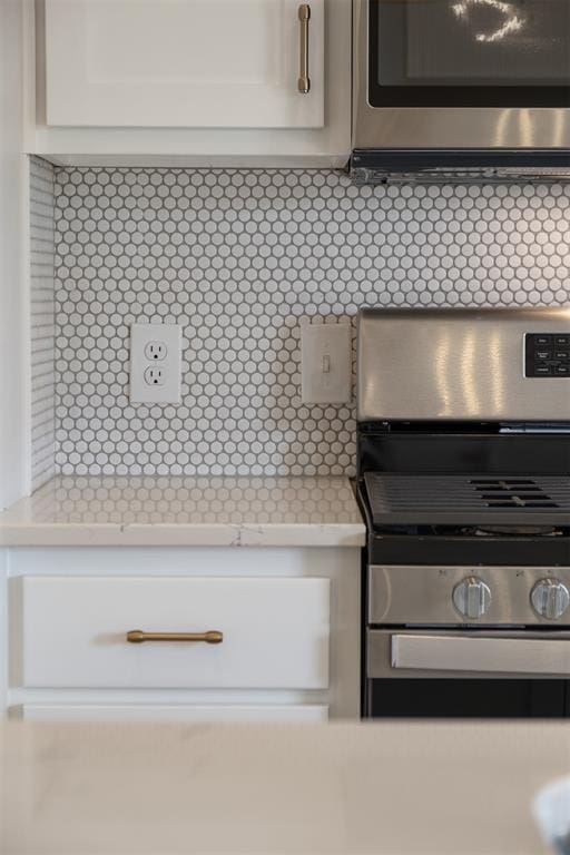 room details with white cabinetry and stainless steel appliances