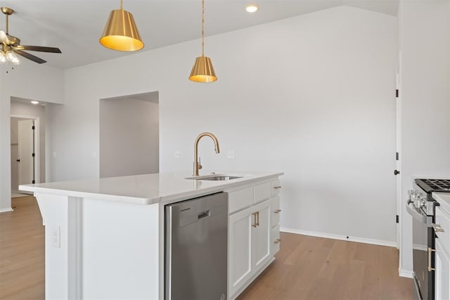 kitchen featuring white cabinetry, an island with sink, light hardwood / wood-style floors, pendant lighting, and appliances with stainless steel finishes