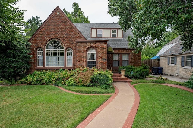 english style home with a front yard