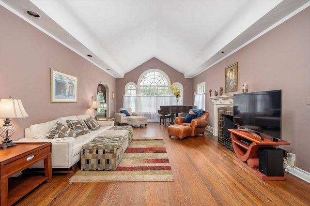 living room featuring a fireplace, lofted ceiling, and hardwood / wood-style flooring