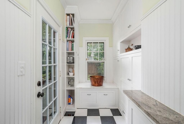 mudroom with built in shelves and crown molding